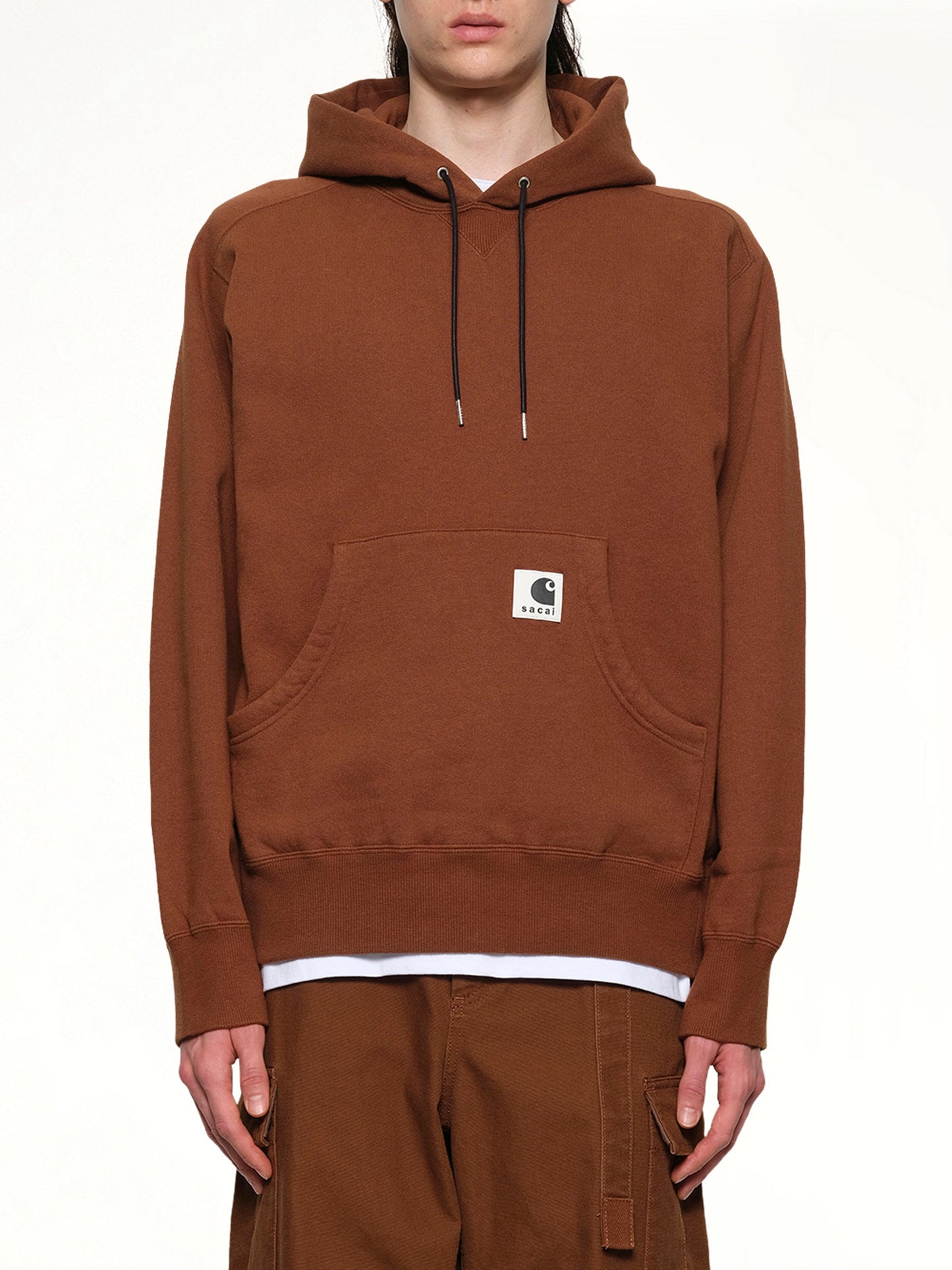 Image of a model wearing Outerwear. Productname: SACAI Carhartt WIP Cotton Jersey Hoodie in Dark Beige colour by brand - SACAI