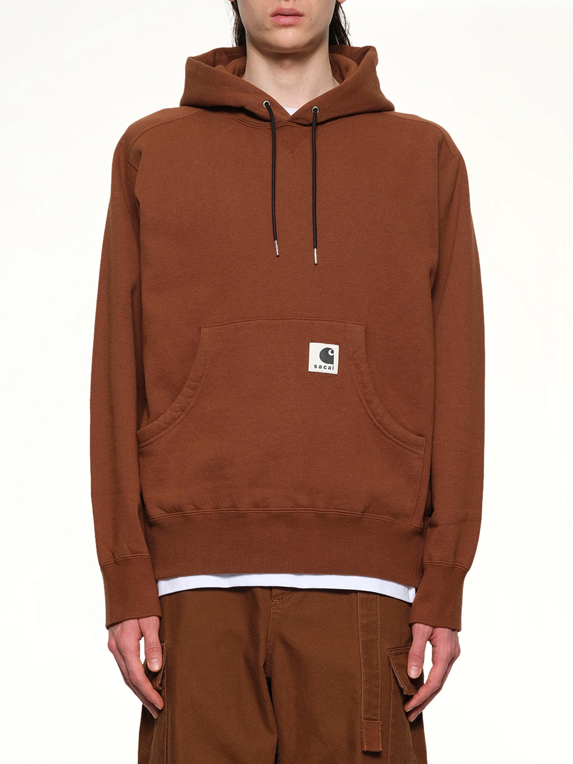 Image of a model wearing Outerwear. Productname: SACAI Carhartt WIP Cotton Jersey Hoodie in Dark Beige colour by brand - SACAI