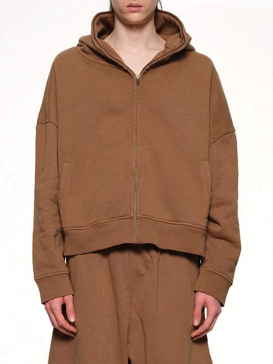 Image of a model wearing Outerwear. Productname: ENTIRE STUDIOS Eternal Zip Hoodie in DUNE colour by brand - ENTIRE STUDIOS