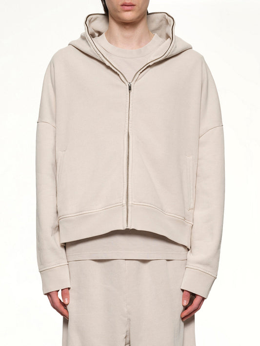 Image of a model wearing Outerwear. Productname: ENTIRE STUDIOS Eternal Zip Hoodie in OFF WHITE colour by brand - ENTIRE STUDIOS