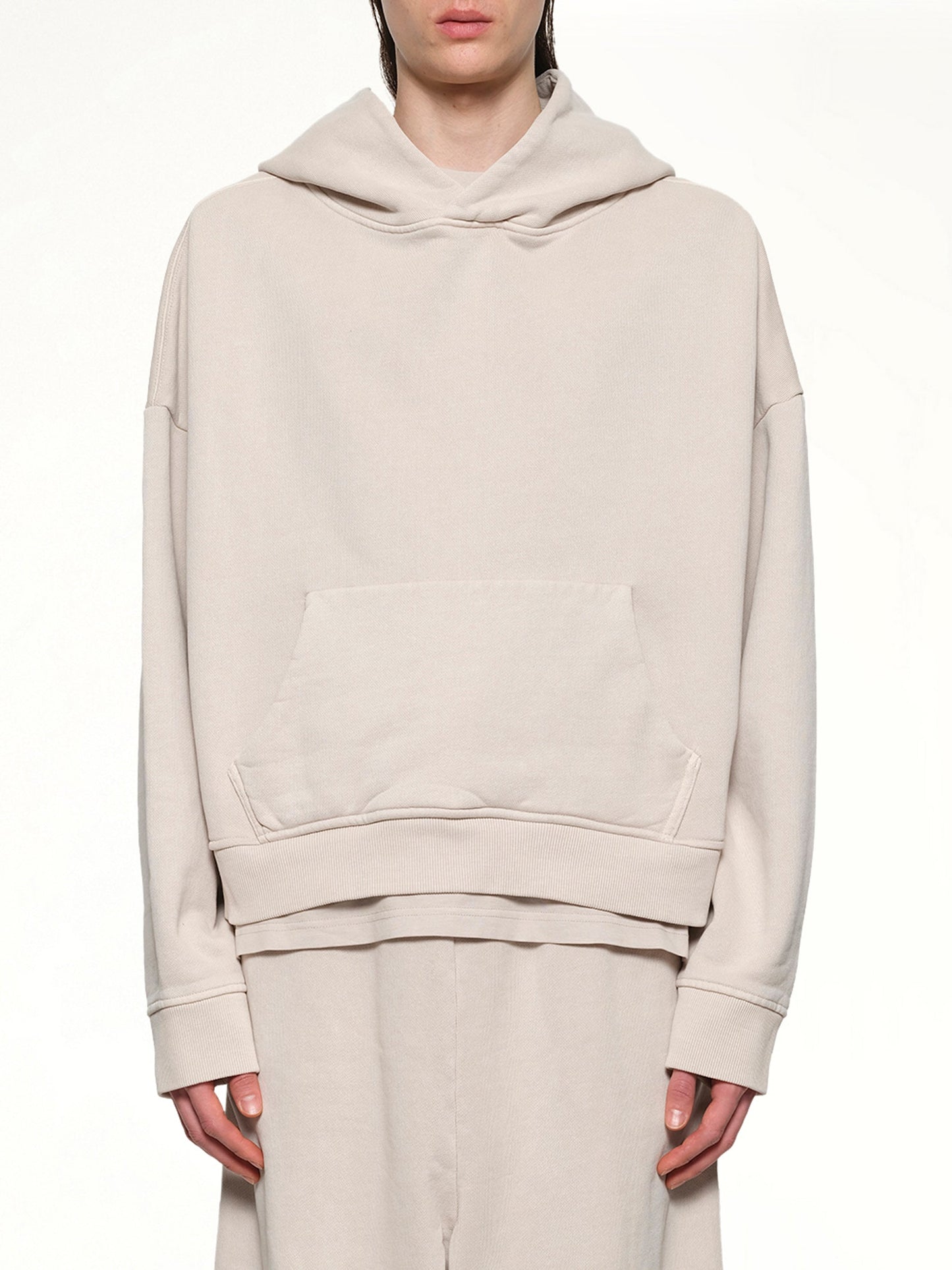 Image of a model wearing Outerwear. Product name - Heavy Hood in White colour by brand - ENTIRE STUDIOS