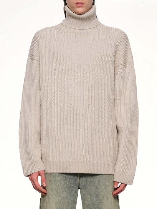 Image of a model wearing Outerwear. Productname: ENTIRE STUDIOS Chunky Turtleneck in BEIGE colour by brand - ENTIRE STUDIOS