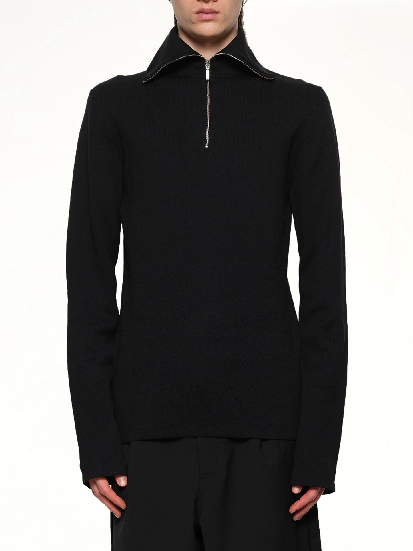 Image of a model wearing Outerwear. Product name - Zip Up Turtle Neck in Black colour by brand - ENTIRE STUDIOS
