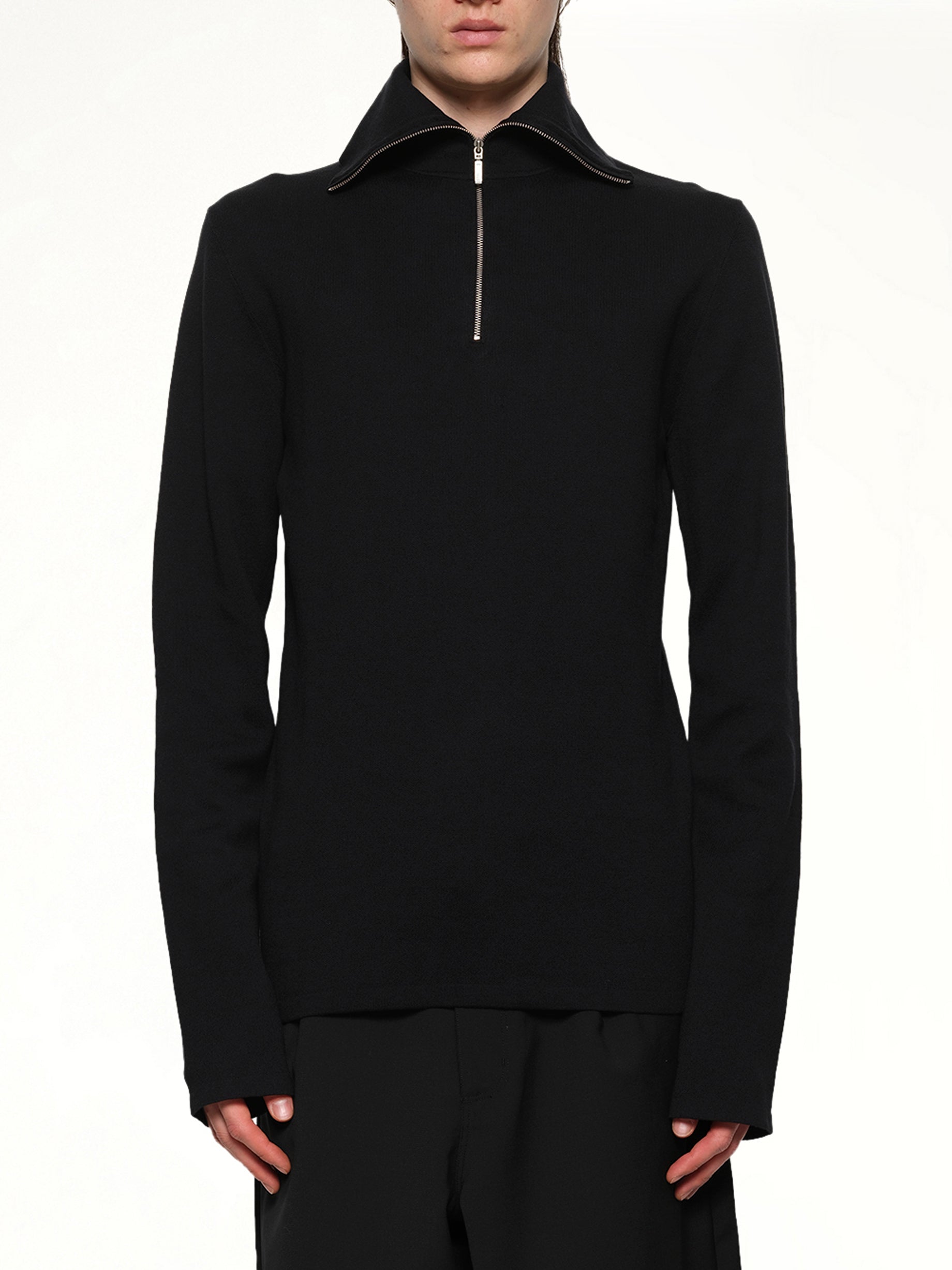 Image of a model wearing Outerwear. Product name - Zip Up Turtle Neck in Black colour by brand - ENTIRE STUDIOS