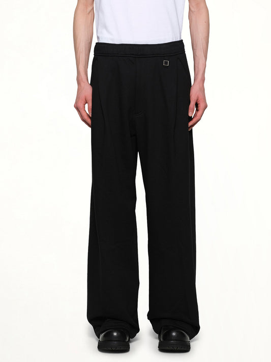 Image of a model wearing Pants. Productname: WOOYOUNGMI Barrel Sweatpants in BLACK colour by brand - WOOYOUNGMI