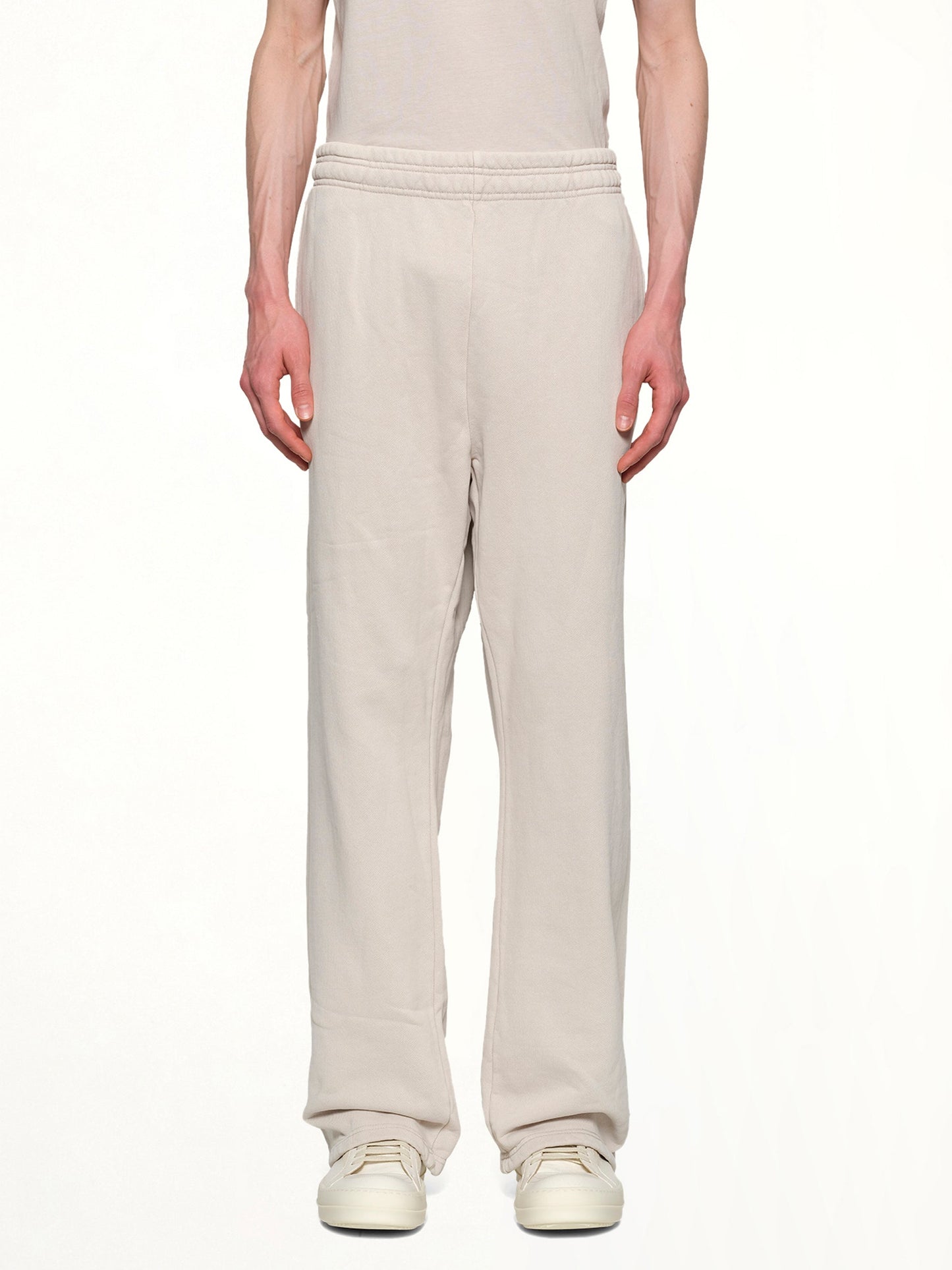 Image of a model wearing Pants. Productname: ENTIRE STUDIOS Straight Leg Sweatpants in OFF WHITE colour by brand - ENTIRE STUDIOS