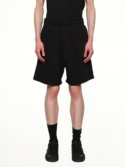 Image of a model wearing Shorts. Product name - Standard Sweatshorts in Black colour by brand - ENTIRE STUDIOS