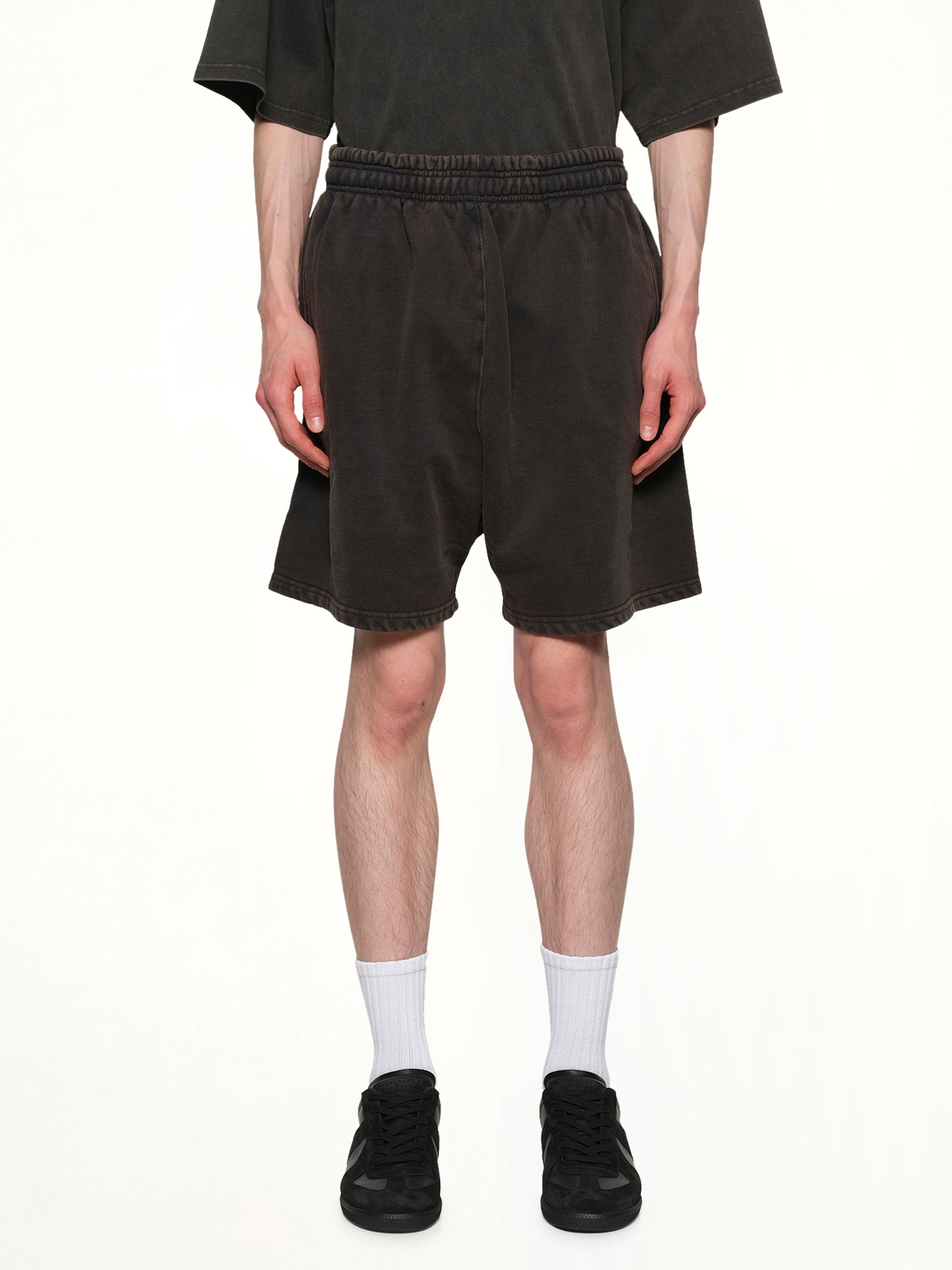 Image of a model wearing Shorts. Product name - Standard Sweatshorts in Black colour by brand - ENTIRE STUDIOS
