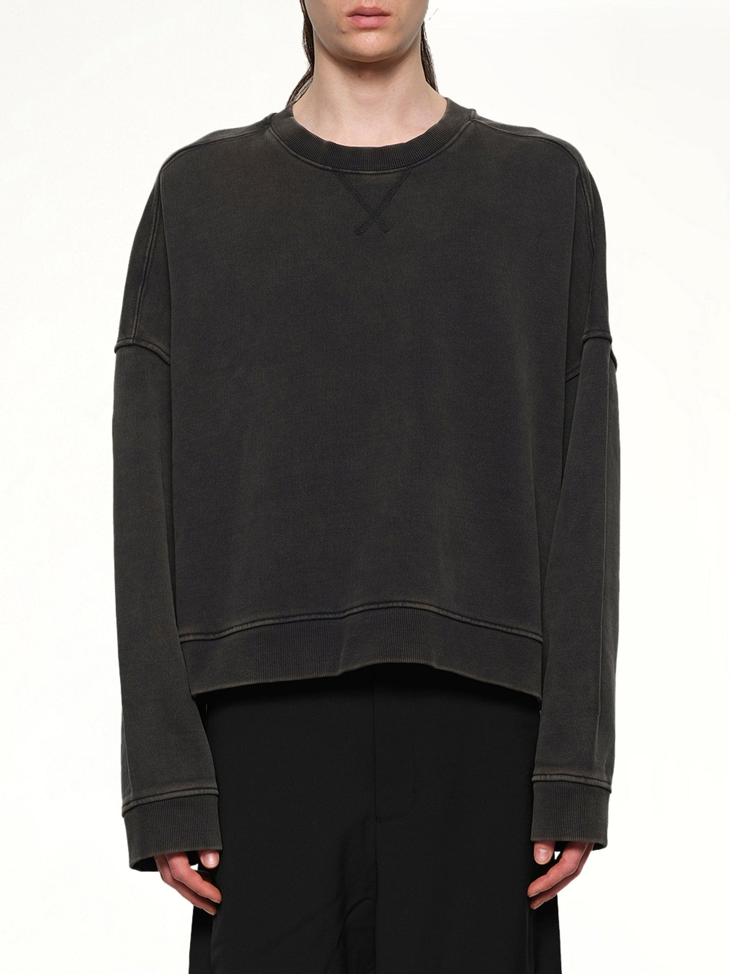 Image of a model wearing Outerwear. Product name - Box Crewneck in Black colour by brand - ENTIRE STUDIOS