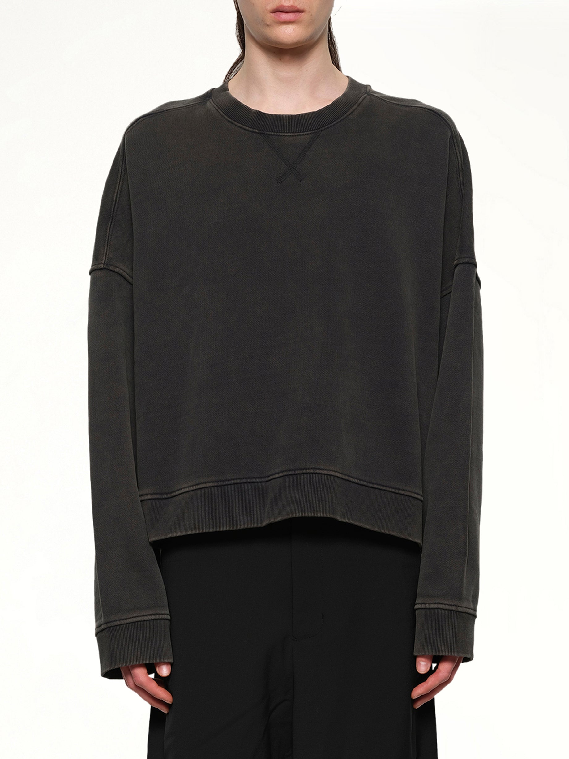 Image of a model wearing Outerwear. Product name - Box Crewneck in Black colour by brand - ENTIRE STUDIOS