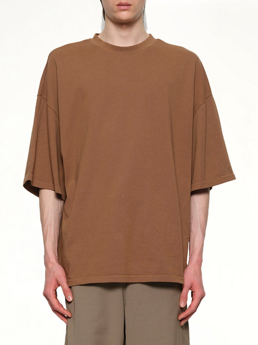 Image of a model wearing Tops. Productname: ENTIRE STUDIOS Heavy Boxy T-Shirt in DUNE colour by brand - ENTIRE STUDIOS