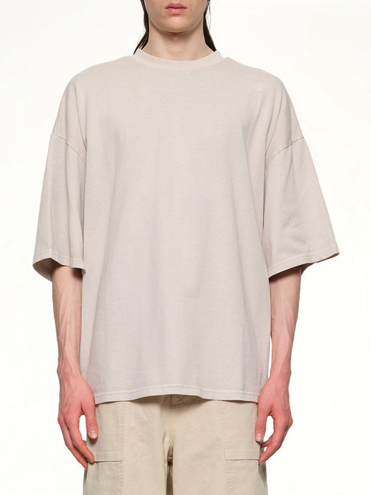 Image of a model wearing Tops. Productname: ENTIRE STUDIOS Heavy Boxy T-Shirt in OFF WHITE colour by brand - ENTIRE STUDIOS