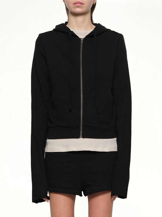 Image of a model wearing Outerwear. Product name - Lightweight Cropped Zip-Up Hoodie in Black colour by brand - ENTIRE STUDIOS