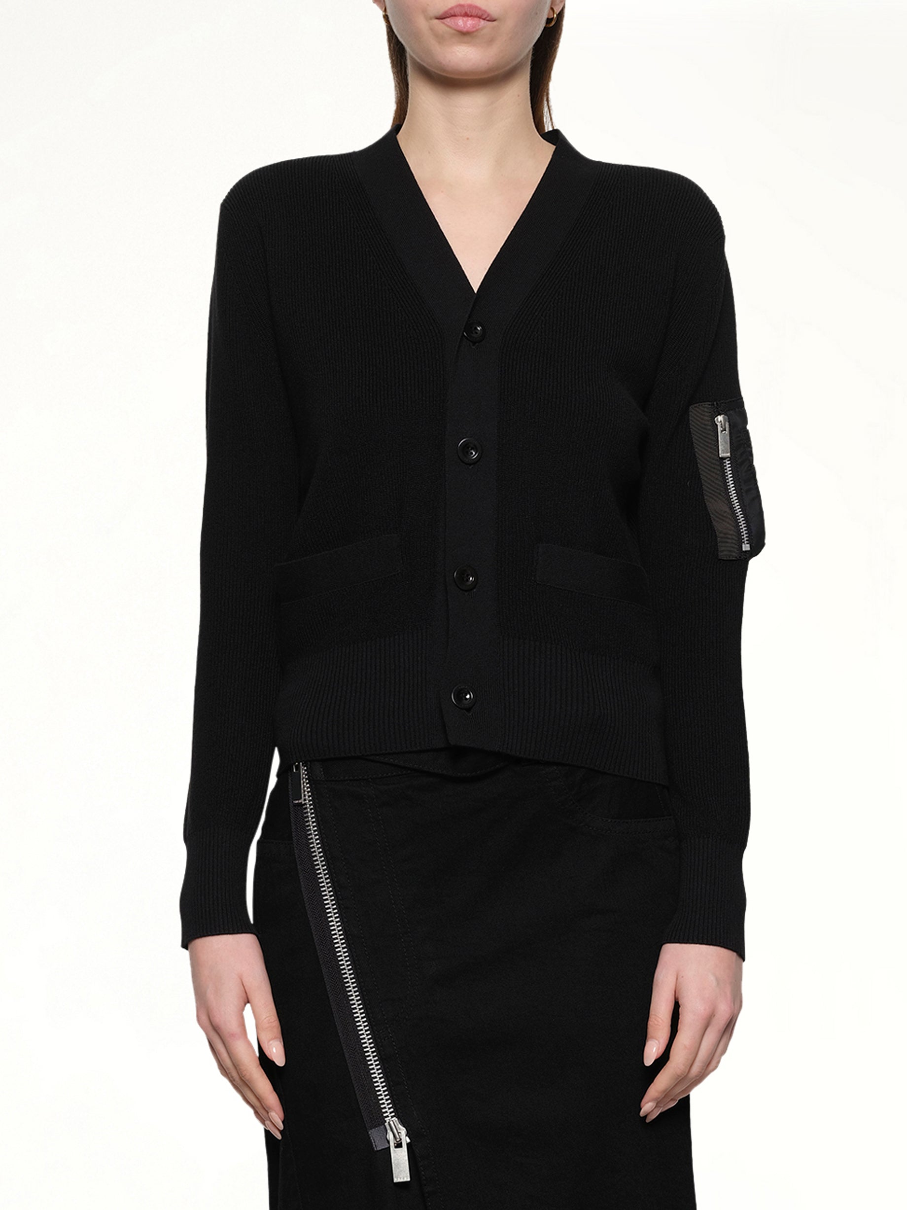 Image of a model wearing Outerwear. Productname: SACAI Nylon Twill x Cotton Knit Cardigan in Black colour by brand - SACAI