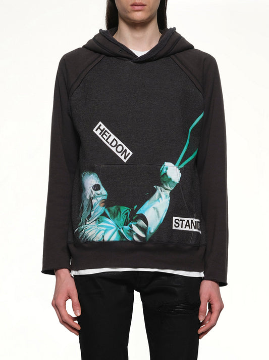 Image of a model wearing Outerwear. Productname: UNDERCOVER Heldon Stand By Hoodie in BLACK colour by brand - UNDERCOVER