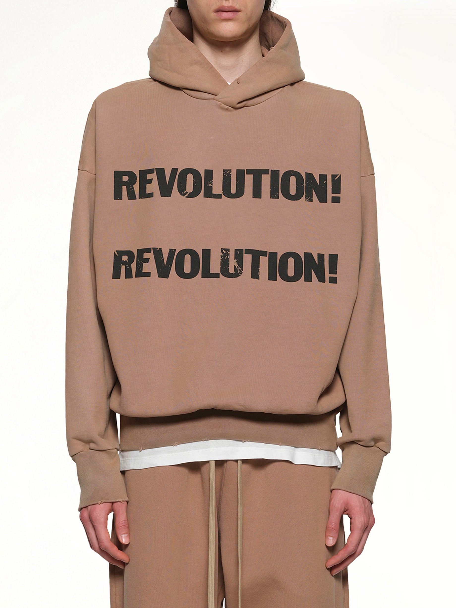 Image of a model wearing Outerwear. Product name - Revolution Hoodie in Dune colour by brand - FEAR OF GOD