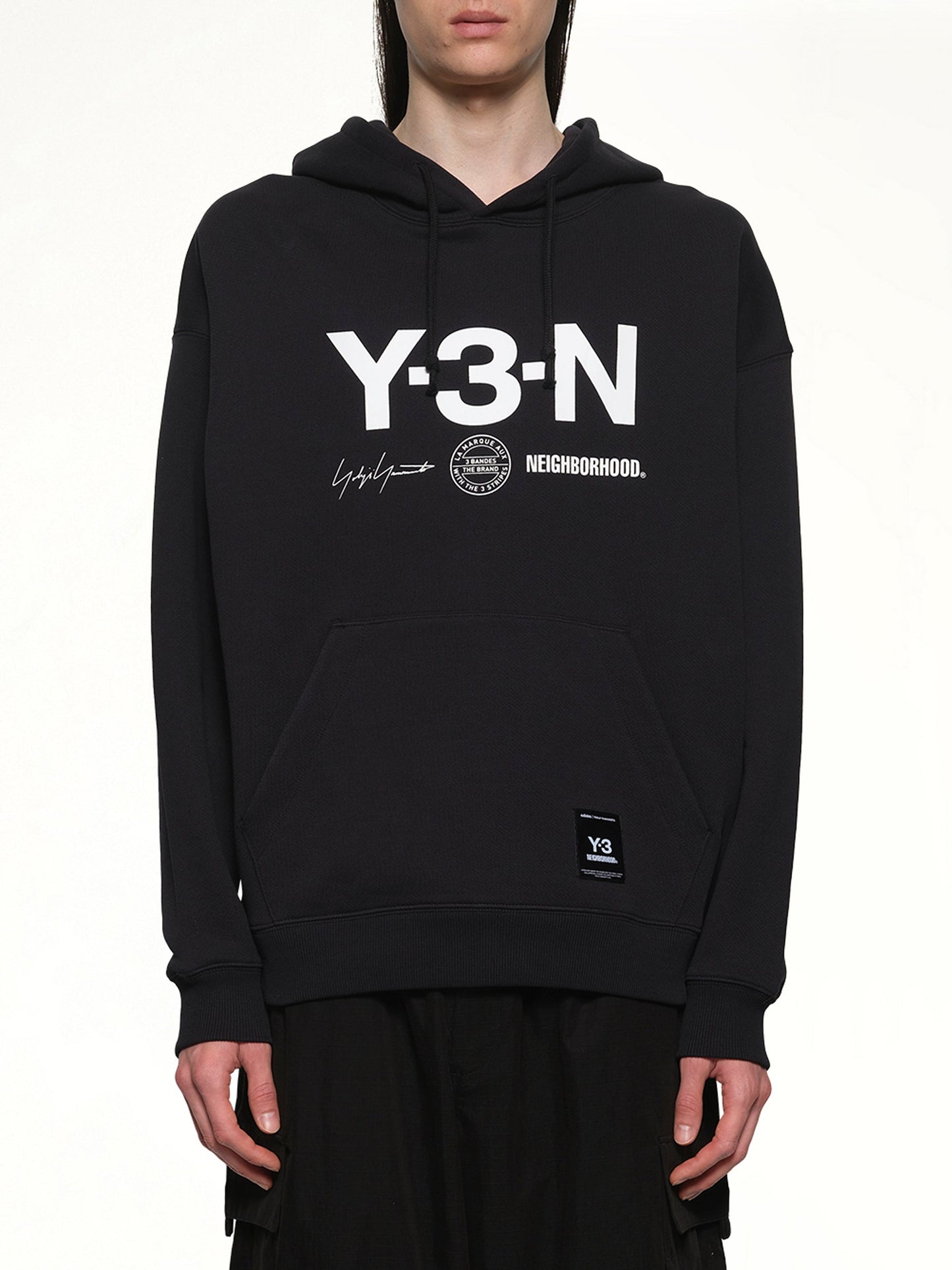 Image of a model wearing Outerwear. Product name - Y-3 X NBHD Graphic Hoodie in Black colour by brand - Y-3