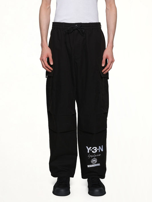 Image of a model wearing Pants. Product name - Y-3 X NBHD Cargo Pants in Black colour by brand - Y-3