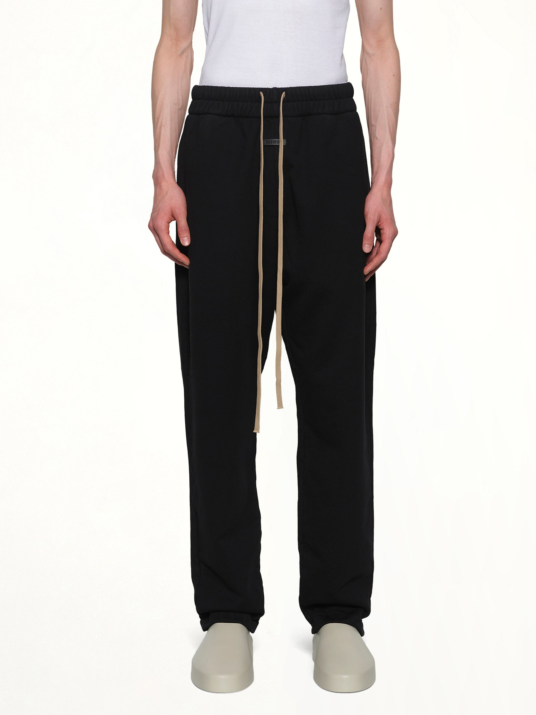 Image of a model wearing Pants. Product name - Relaxed Sweatpant in Black colour by brand - FEAR OF GOD