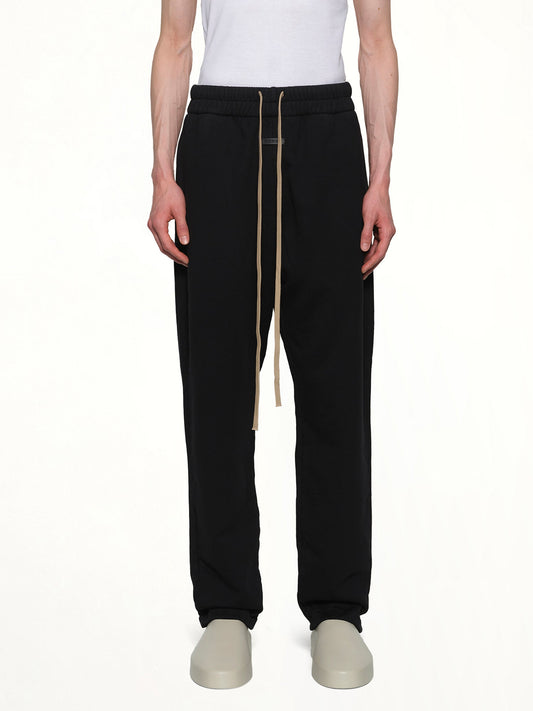 Image of a model wearing Pants. Product name - Relaxed Sweatpant in Black colour by brand - FEAR OF GOD