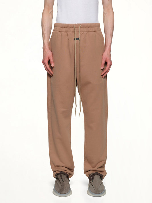Image of a model wearing Pants. Product name - Relaxed Sweatpant in Dune colour by brand - FEAR OF GOD