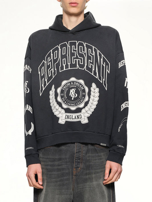 Image of a model wearing Outerwear. Product name - Represent Legacy Crest Hoodie in Stained Black colour by brand - REPRESENT