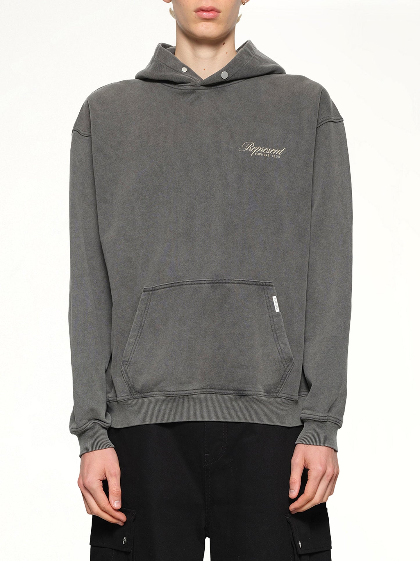 Image of a model wearing Outerwear. Product name - Represent Owners Club Script Hoodie in Grey colour by brand - REPRESENT