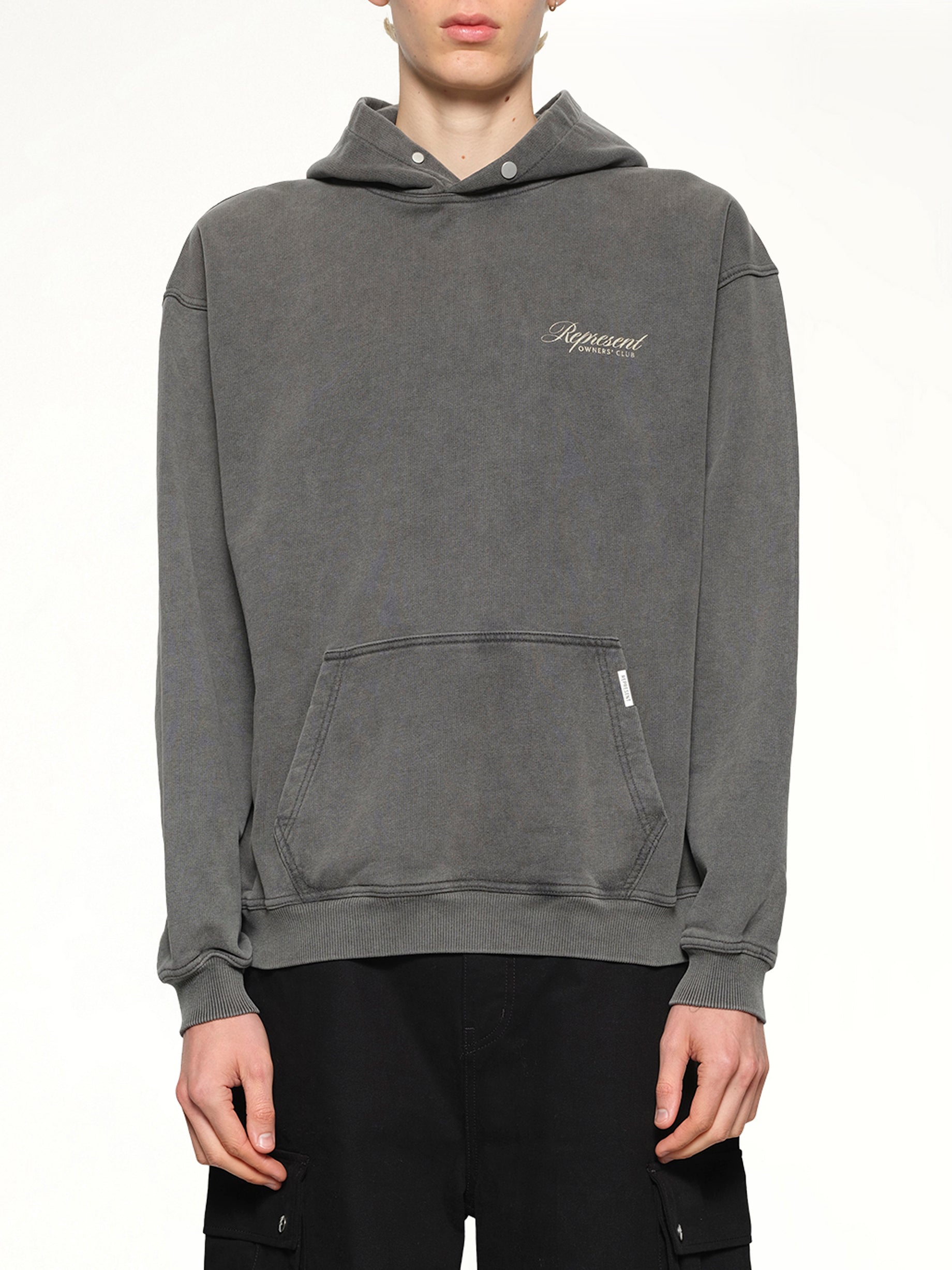 Image of a model wearing Outerwear. Product name - Represent Owners Club Script Hoodie in Grey colour by brand - REPRESENT