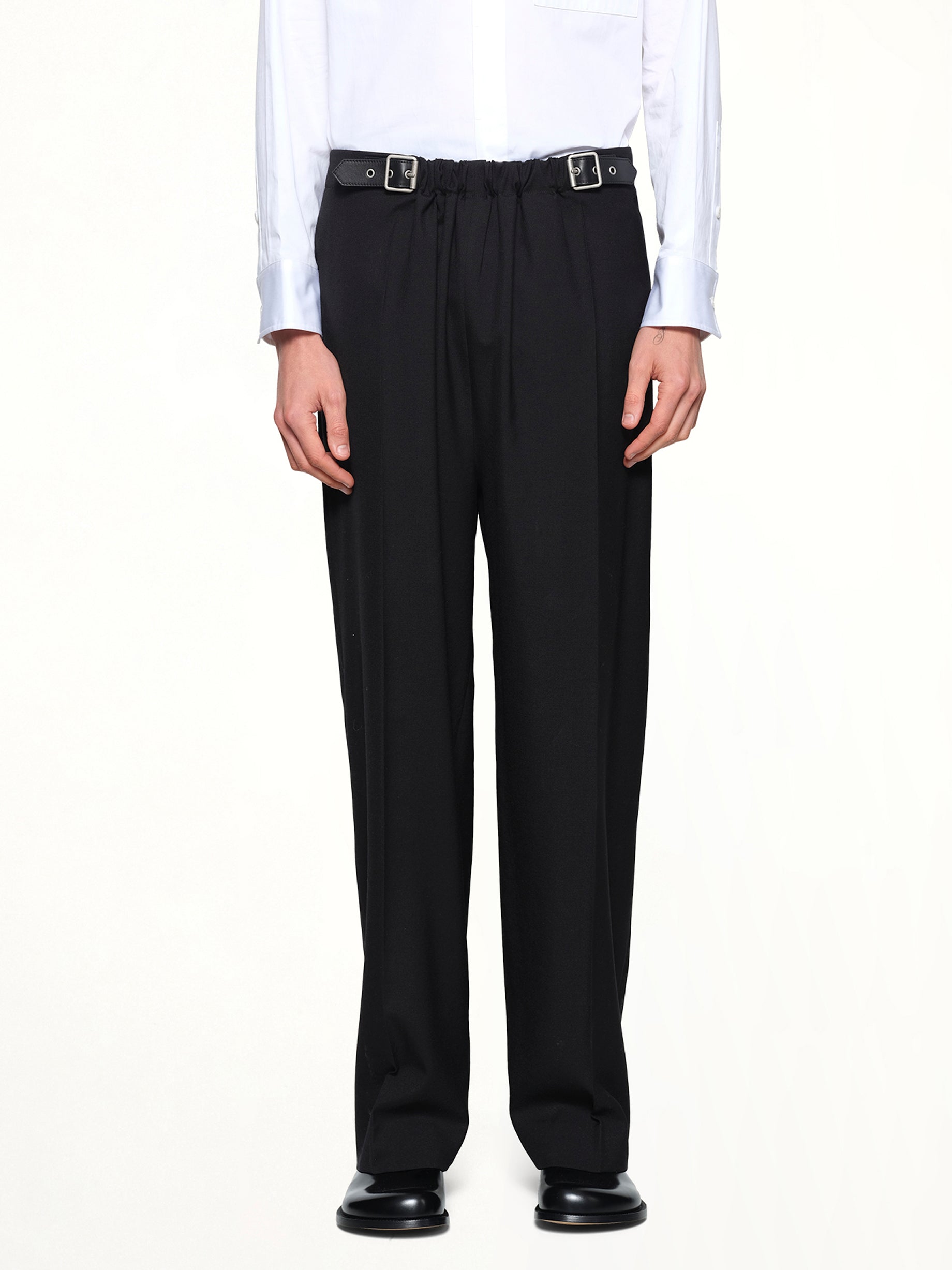 Image of a model wearing Pants. Product name - Belted Trousers in Black colour by brand - LOEWE
