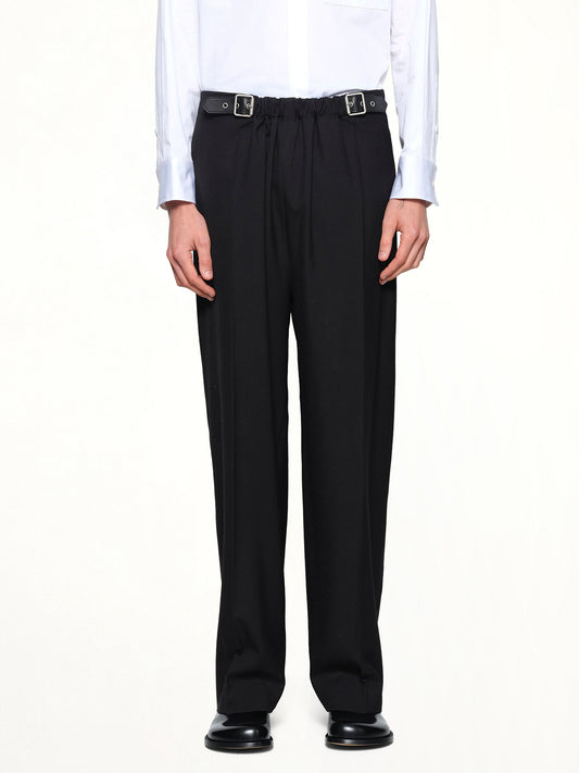 Image of a model wearing Pants. Product name - Belted Trousers in Black colour by brand - LOEWE