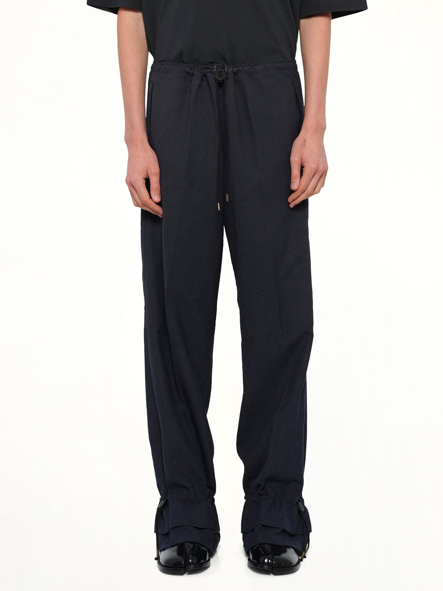 Image of a model wearing Pants. Product name - Wool Pants in Dark Blu colour by brand - MAISON MARGIELA