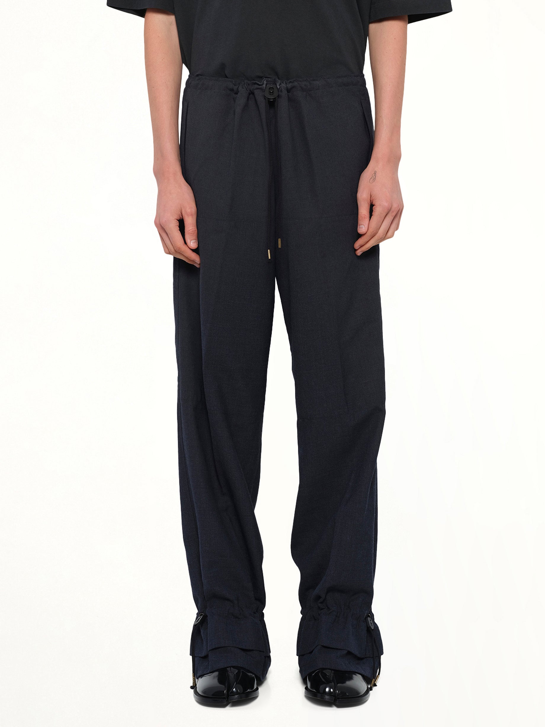 Image of a model wearing Pants. Product name - Wool Pants in Dark Blu colour by brand - MAISON MARGIELA
