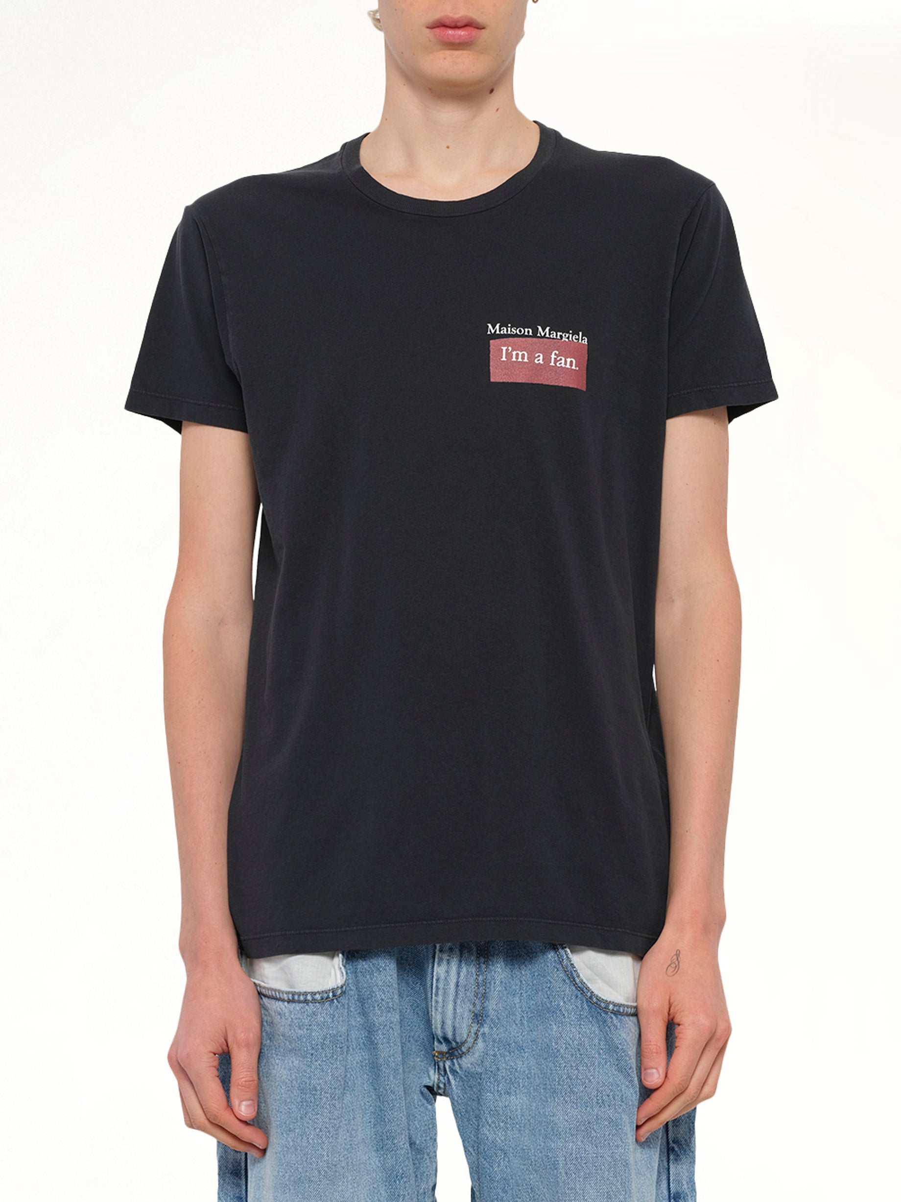 Image of a model wearing Tops. Productname: MAISON MARGIELA "I'm a Fan" T-Shirt in Charcoal colour by brand - MAISON MARGIELA