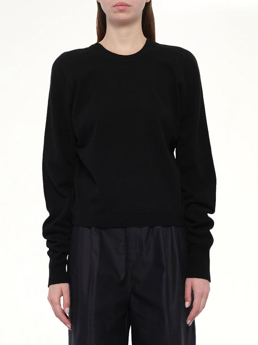 Image of a model wearing Outerwear. Product name - Gauge 14 Gathered Sweater in Black colour by brand - MAISON MARGIELA