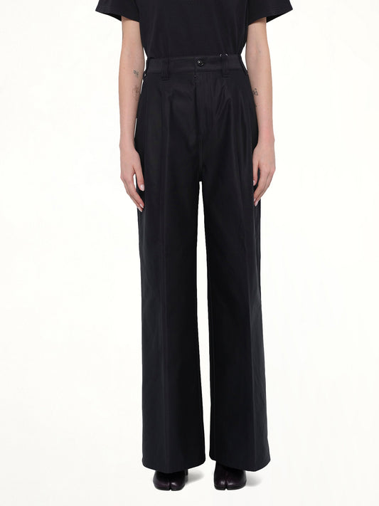 Image of a model wearing Pants. Product name - Cotton Palazzo Trouser in Black colour by brand - MAISON MARGIELA