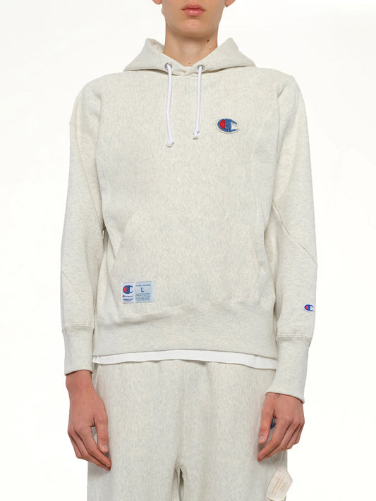Image of a model wearing Outerwear. Product name - Undercover X Champion Hoodie in Beige colour by brand - UNDERCOVER