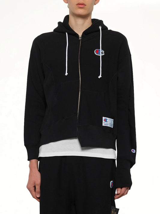 Image of a model wearing Outerwear. Product name - Undercover X Champion Zip Hoodie in Black colour by brand - UNDERCOVER
