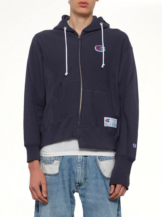 Image of a model wearing Outerwear. Productname: UNDERCOVER Undercover X Champion Zip Hoodie in Navy colour by brand - UNDERCOVER