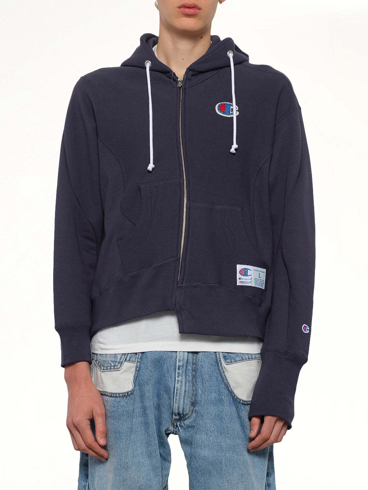 Image of a model wearing Outerwear. Product name - Undercover X Champion Zip Hoodie in Navy colour by brand - UNDERCOVER