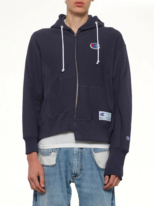 Image of a model wearing Outerwear. Product name - Undercover X Champion Zip Hoodie in Navy colour by brand - UNDERCOVER