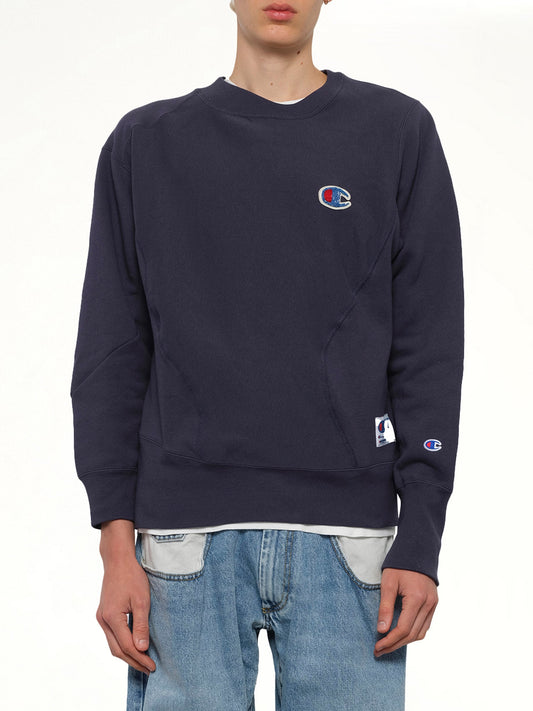 Image of a model wearing Outerwear. Productname: UNDERCOVER Undercover X Champion Sweatshirt in Navy colour by brand - UNDERCOVER