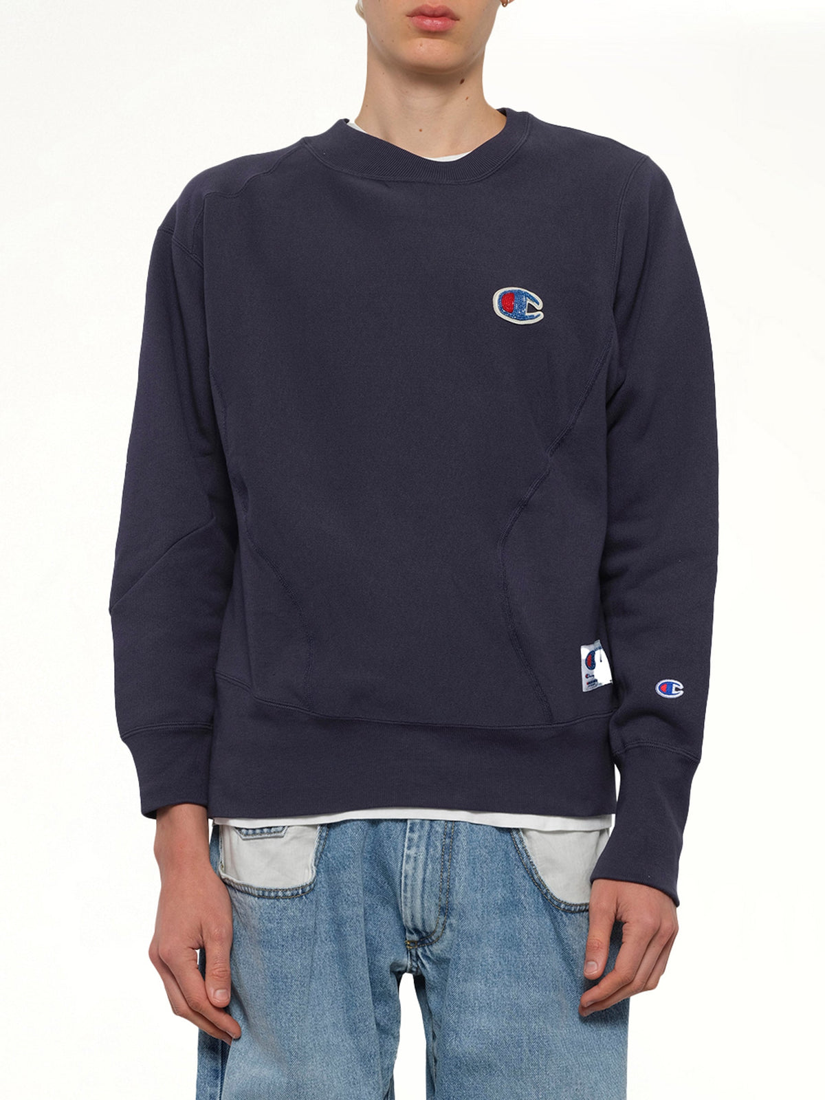 Image of a model wearing Outerwear. Product name - Undercover X Champion Sweatshirt in Navy colour by brand - UNDERCOVER