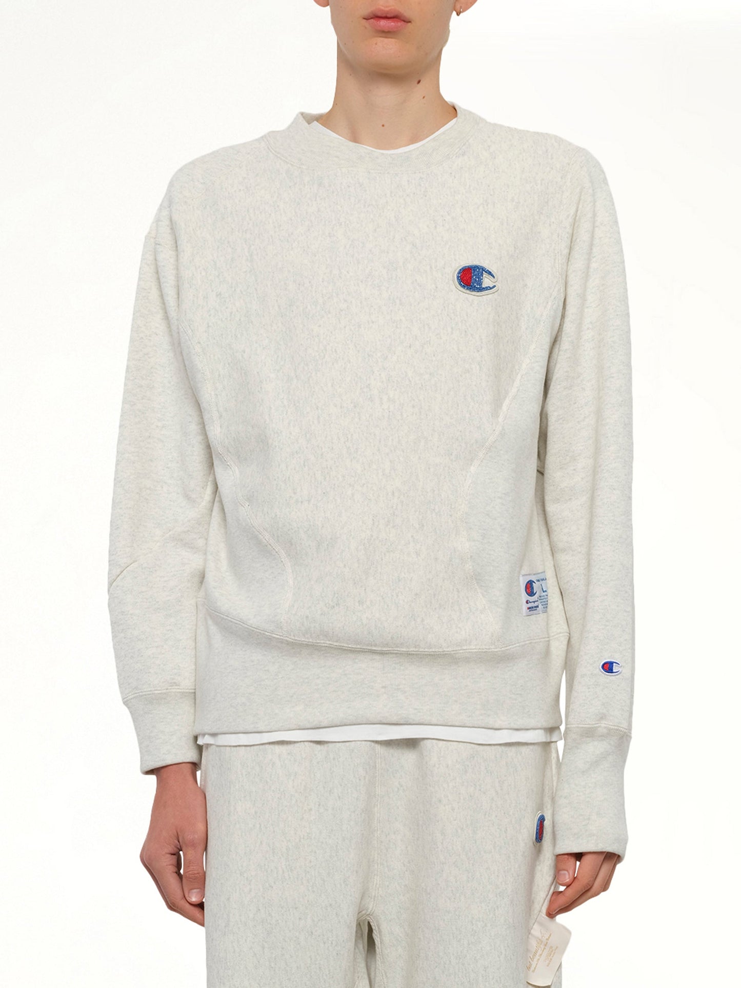 Image of a model wearing Outerwear. Product name - Undercover X Champion Sweatshirt in Beige colour by brand - UNDERCOVER