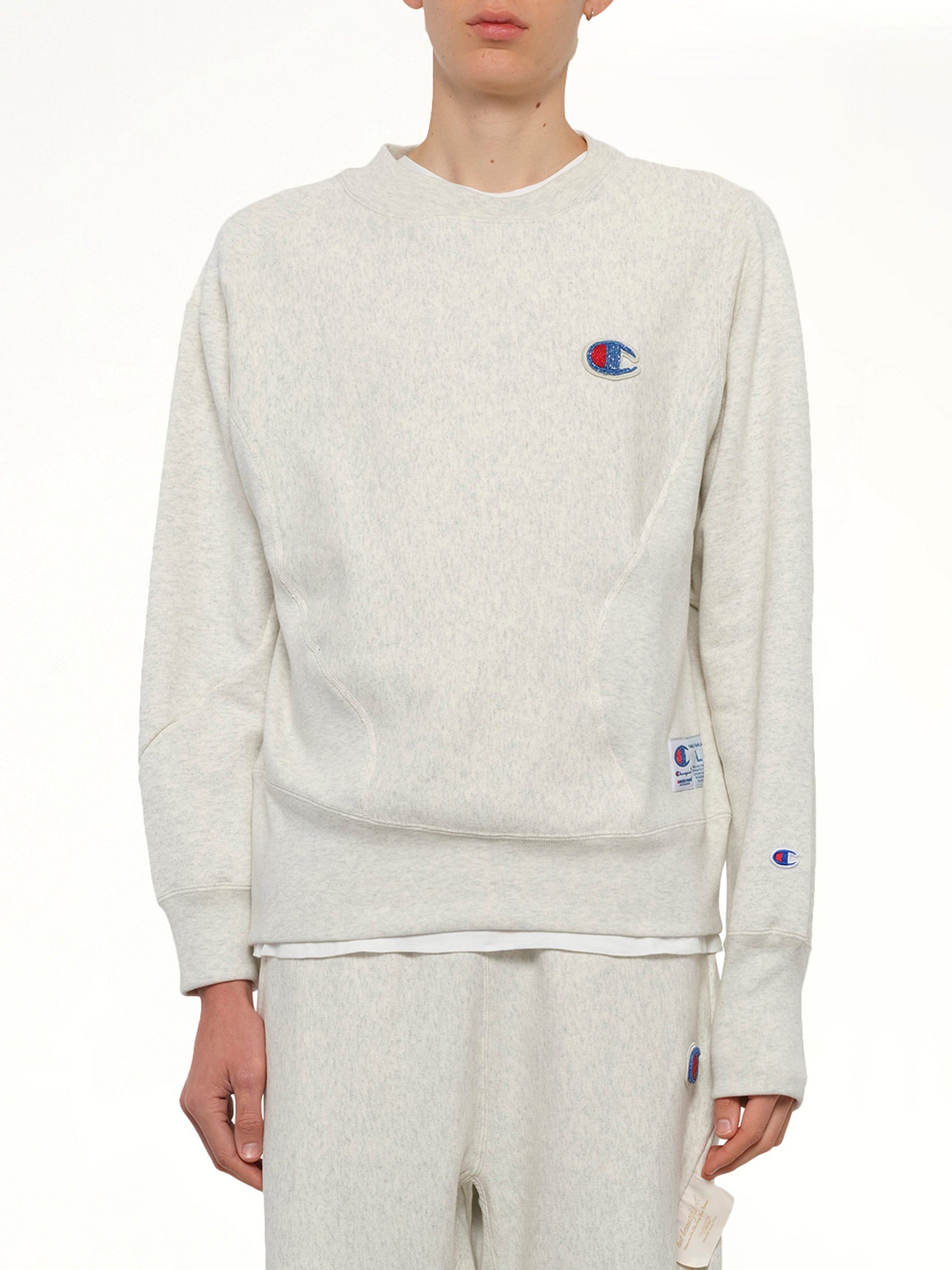 Image of a model wearing Outerwear. Product name - Undercover X Champion Sweatshirt in Beige colour by brand - UNDERCOVER
