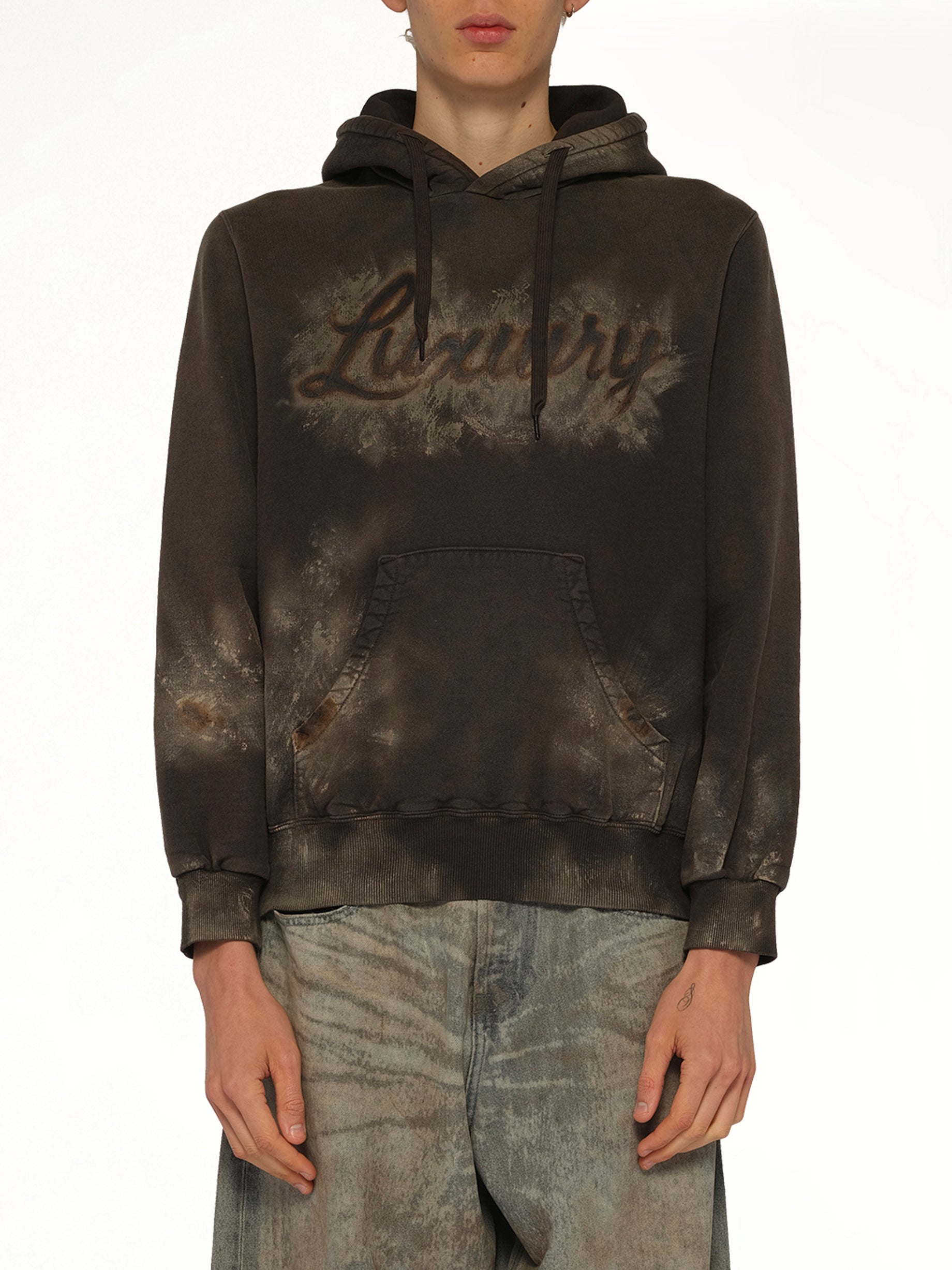 Image of a model wearing Outerwear. Product name - Luxuary Mud Paint Hoodie in Brown colour by brand - DOUBLET