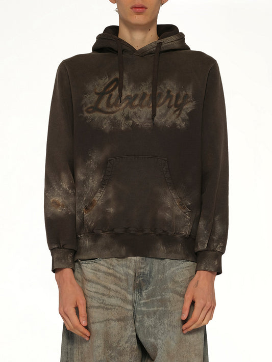 Image of a model wearing Outerwear. Product name - Luxuary Mud Paint Hoodie in Brown colour by brand - DOUBLET
