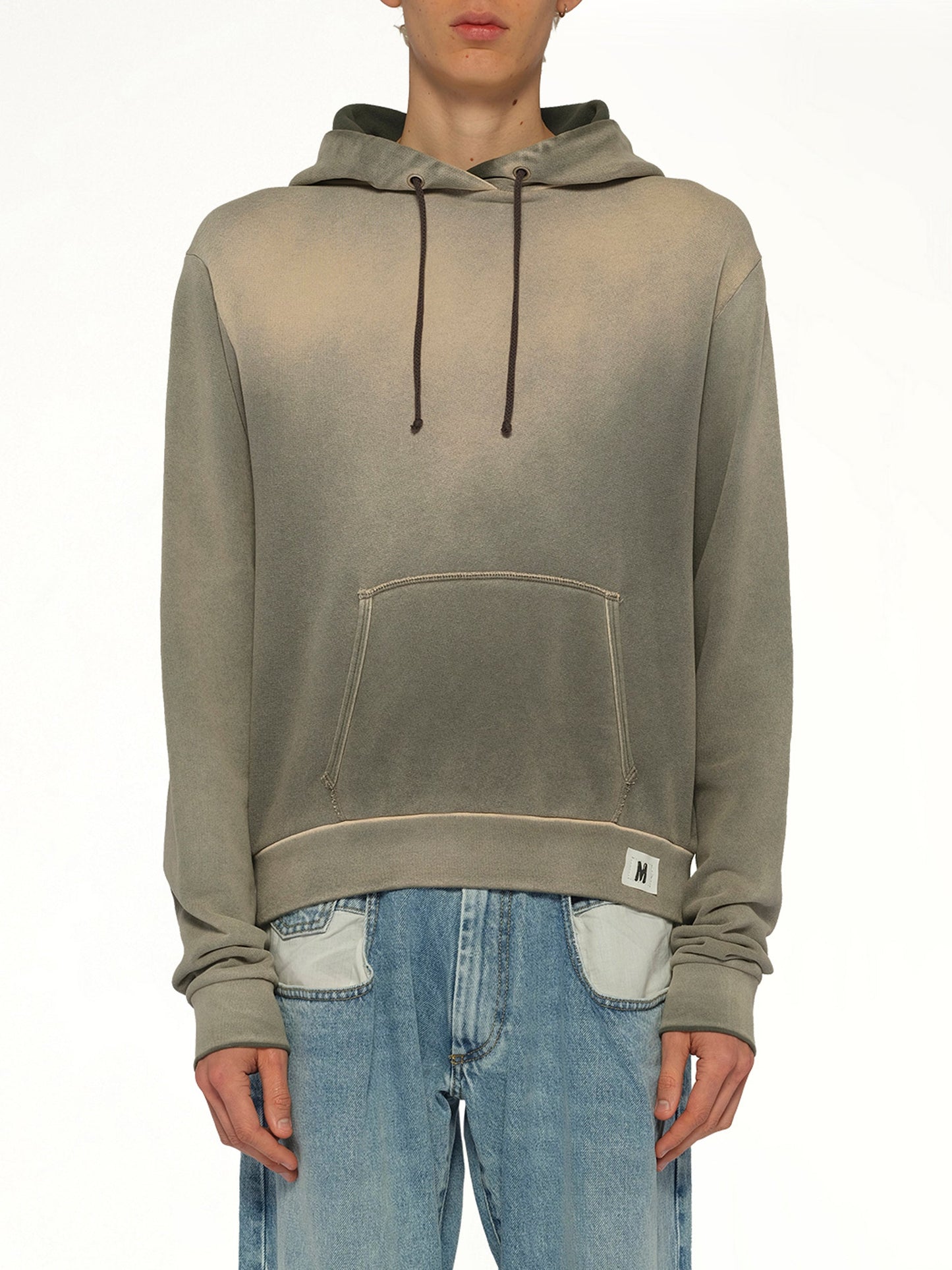 Image of a model wearing Outerwear. Product name - Overdyed Hoodie in Khaki colour by brand - MAISON MARGIELA