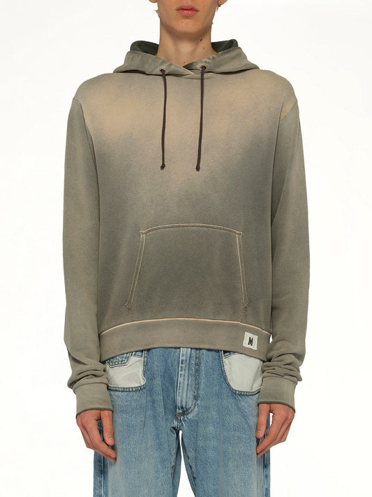 Image of a model wearing Outerwear. Product name - Overdyed Hoodie in Khaki colour by brand - MAISON MARGIELA