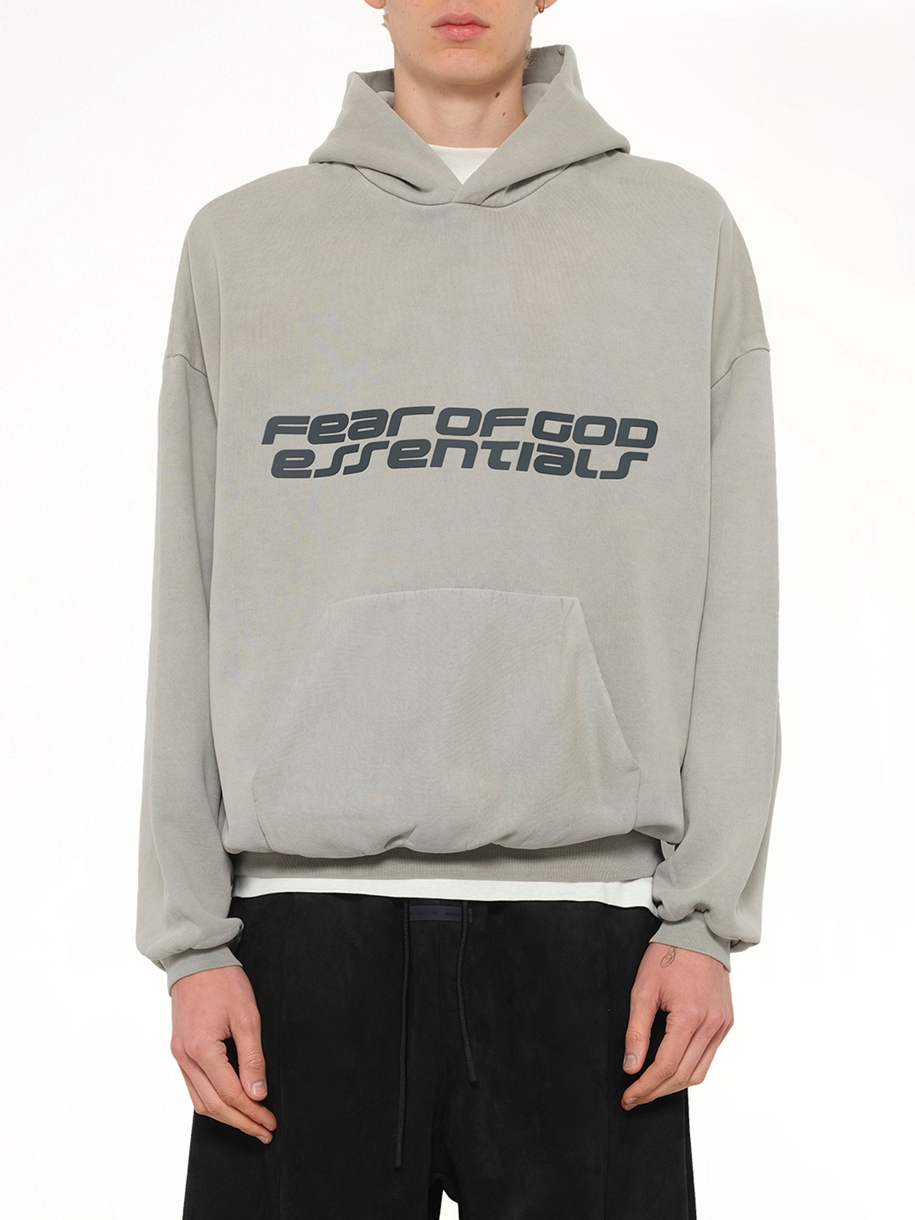 Image of a model wearing Outerwear. Product name - 90's Hoodie in Smoke Grey colour by brand - FEAR OF GOD ESSENTIALS