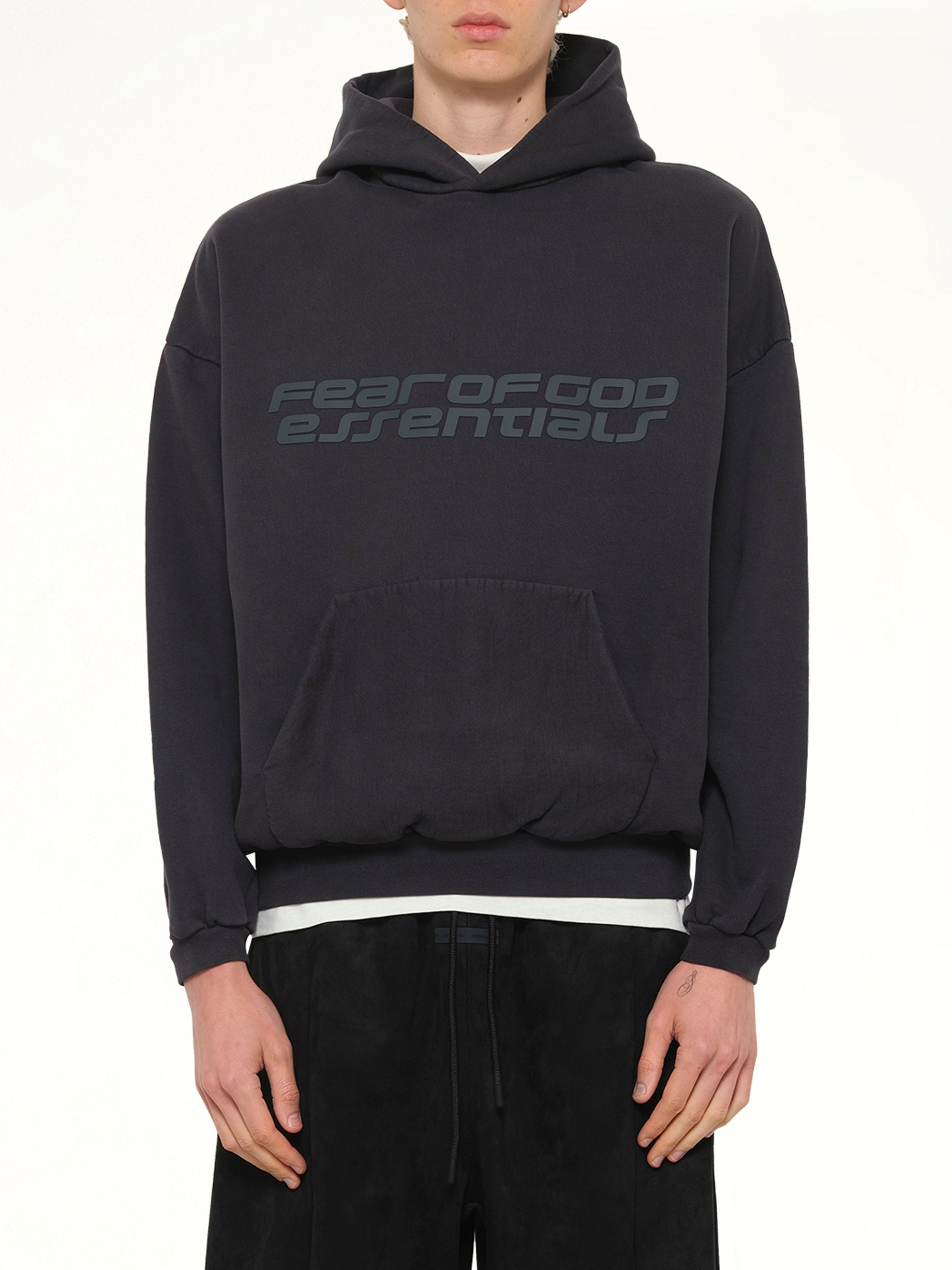 Image of a model wearing Outerwear. Product name - 90's Hoodie in Black colour by brand - FEAR OF GOD ESSENTIALS